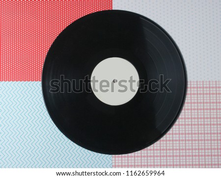 Vinyl plate on a creative background, top view
