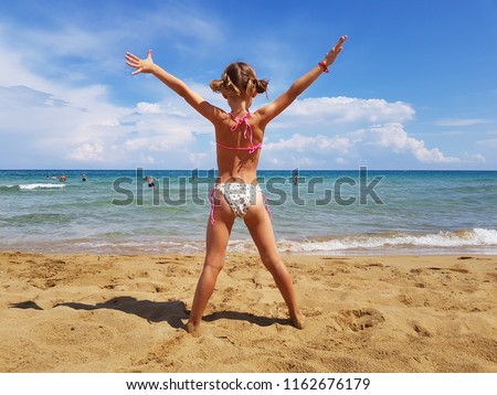 girl on the sea,a little girl stands with her back to the sea, a beautiful figure, a tan, a sun on the sea, rest, a sunny day on the sea, a girl sunbathes, rest on the ocean, health, holidays on the s Royalty-Free Stock Photo #1162676179
