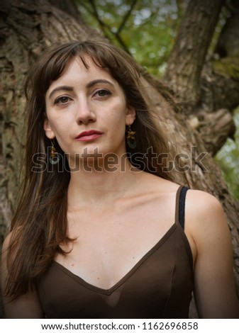 Young woman sad in woods