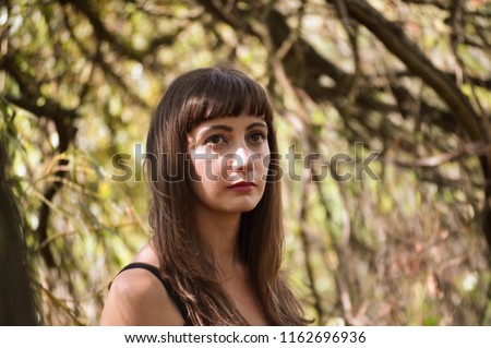 Young woman sad in woods