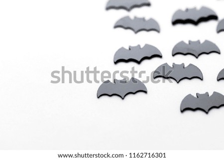 Black bat shapes on a white background. Halloween background