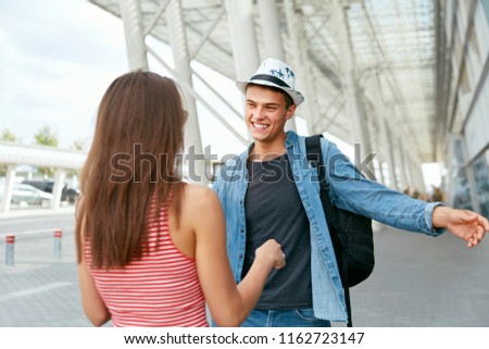 Couple Meeting After Long Time, Running To Each Other Near Airport. People Meeting After Long Parting At Arrival Terminal. High Resolution