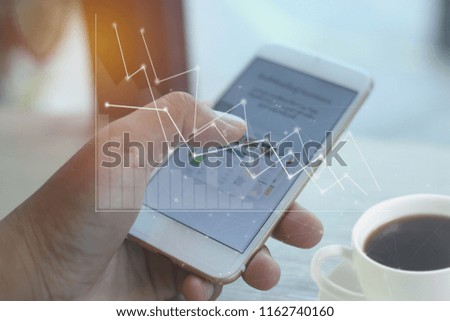Business man hand working with  new modern smart phone or mobile and business strategy (graph)