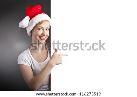 Christmas Santa woman is showing blank empty billboard. sale. New year