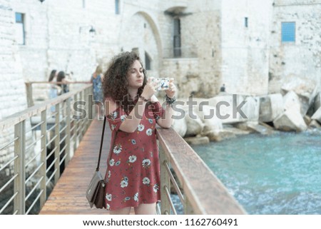 Young Woman take a photo at Giovinazzo's sea