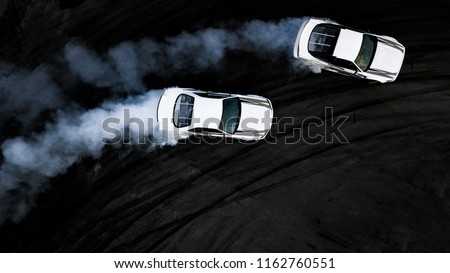 Two car drifting battle on asphalt street rad race track, Race car drift performance view from above, Car drifting, Automobile and automotive drift car with smoke from burning tire on speed track. Royalty-Free Stock Photo #1162760551
