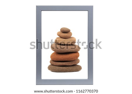 Stone stack in grey picture frame isolated on white background