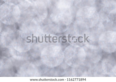 Defocused Gentle delicate lilac pastel glitter lights background. Blurred Bokeh Christmas light background. Holiday xmas glowing white backdrop. 