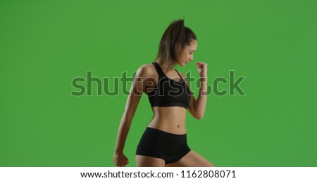 A Hispanic girl does a power pose on green screen