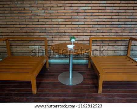Outdoor bench with brick wall background in smoking area zone 