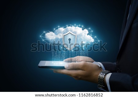 Concept Data protection in tablet . Data cloud with a protective shield shows the businessman.
