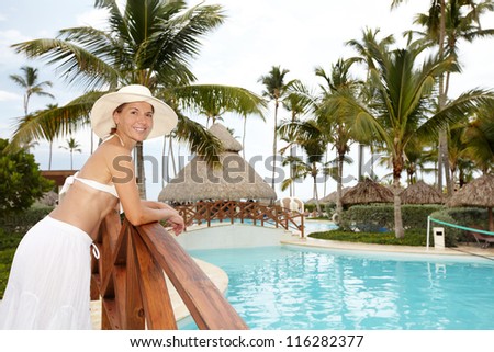 Woman in the tropical garden near the pool.