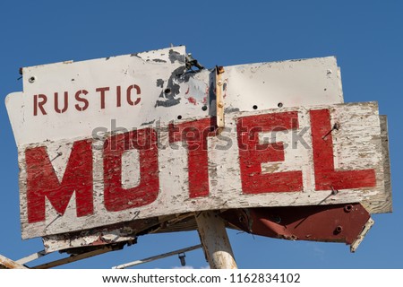 Close up of an abandoned generic rustic retro motel sign is falling apart and decaying in the California desert, near Olancha, CA