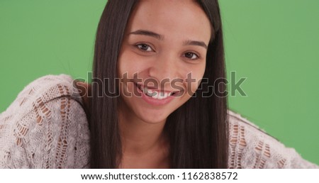 Portrait of a latina girl smiling and posing for the camera on green screen
