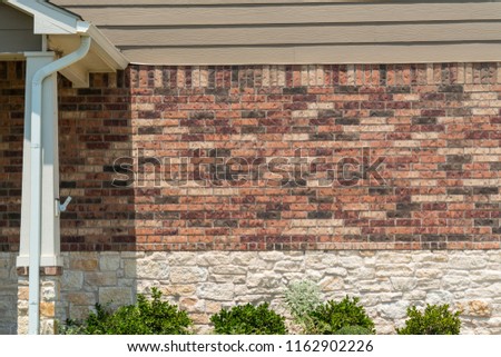 Brick Surfaces with side view of patio entry way outside of front porch of modern brick home