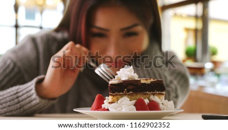 Happy Japanese woman indulges in fancy dessert Royalty-Free Stock Photo #1162902352