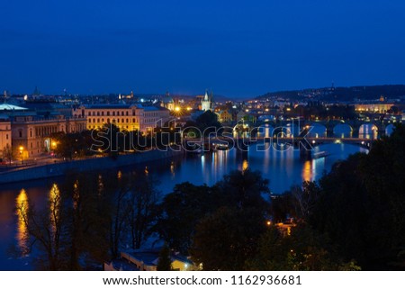  Night landscape or cityscape Picture of bridges over the Vltava river in the old historical city centre or downtown of Prague, capitol of Czech Republic, Europe.                             