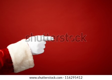 Photo of Santa Claus gloved hand in pointing gesture