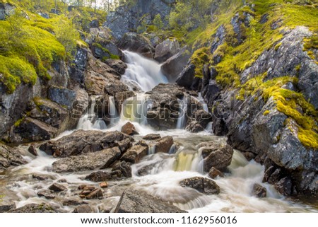Norwegian Waterfall with long exposure and blurred water flow in Hardangervidda national park