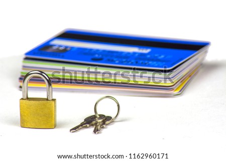 A stack of credit cards. A small padlock and the keys to it.