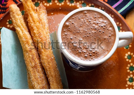 Traditional churros with sugar and chocolate