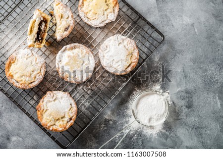 Mince pies, traditional christmas food made from all butter shortcrust pastry pies deep filled with plump vine fruits, such as cranberries, clementine, cherries and brandy