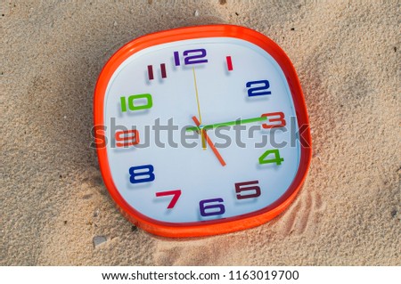 5 o'clock and 15 minutes over the sand background