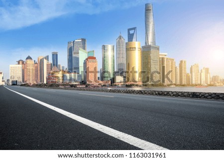 Empty asphalt road along modern commercial buildings in China's 