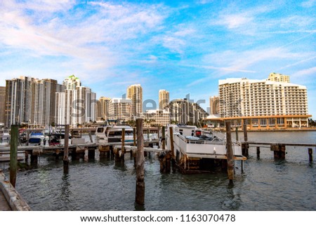 Beautiful view from sea, sky, boats, and office buildings during sunset in Brickell, Miami, United States