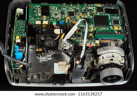 disassembled DLP projector on a black velvet background, flat lay