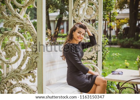 Beautiful hispanic young woman in black elegant dress at city. Autumn or spring fashionable trend 