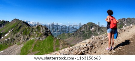 a woman hiker on the trail of  Pic du Midi de Bigorre in the Pyrenees