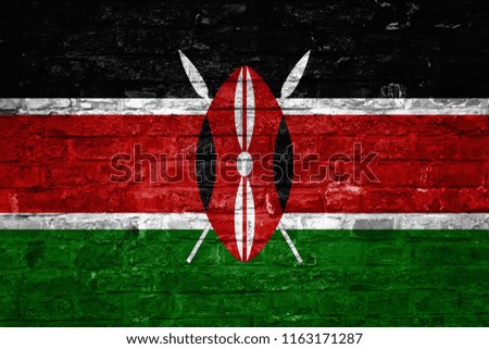 Flag of Kenya over an old brick wall background, surface