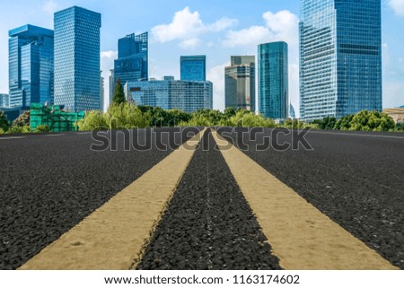 Empty asphalt road along modern commercial buildings in China's 