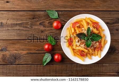 Pasta bolognese with tomato sauce and minced meat, grated parmesan cheese and fresh basil - homemade healthy italian pasta on rustic wooden background. Flat lay. Top view.