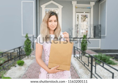 girl with a bag of paper on the street, shopping concept