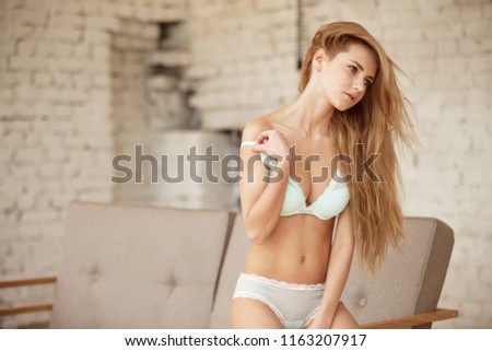 girl posing in photostudio with white wall