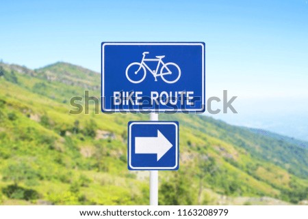 bike route street sign with beautiful mountain and blue sky background