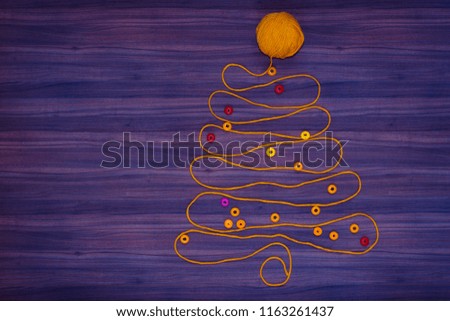 Christmas tree on purple background created orange threads.
