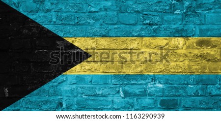 Flag of Bahamas over an old brick wall background, surface.