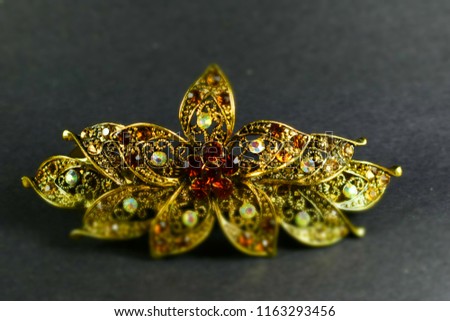Gold flower with stones   Royalty-Free Stock Photo #1163293456