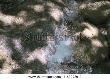 Photography of a small water stream located in a public park (called 'Parc des Etang' in French) near the city of Grenoble, France