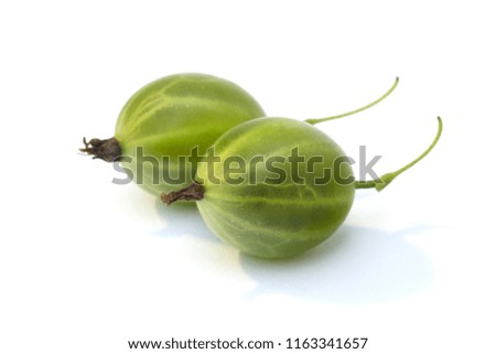 A pair of green gooseberries fruit closeup, isolated on white background. Two green berries of gooseberries isolated on white background in a studio shot.