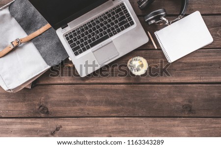 Top view of hipster wooden workspace, office table desk, flat lay image of two coworkers using laptop and discussing at office workspace, mock-up of blank screen of laptop computer and mobile phone. 