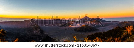 Aerial Panorama  Sunrise view of Mt.Bromo,Mt.Semeru,Mt.Batok covered with fog and sulfur gas with colorful Sky in  East Java, Indonesia