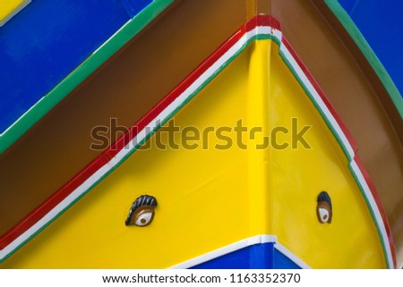 Front view of colorful painted wood boat with the typical protective eyes, Malta.