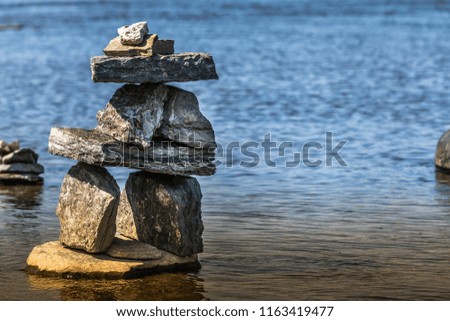 Inukshuk by the river edge.