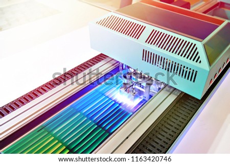 Large format UV coating printer in work