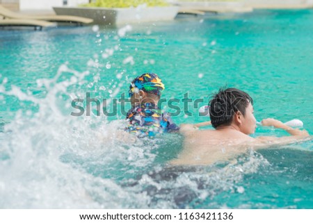 Little boy learning to swim with his father. Background. Selective focus. Copy space.