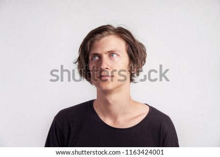 Portrait of young handsome hipster man look surprised disappointment, black t-shirt, white background.
                            